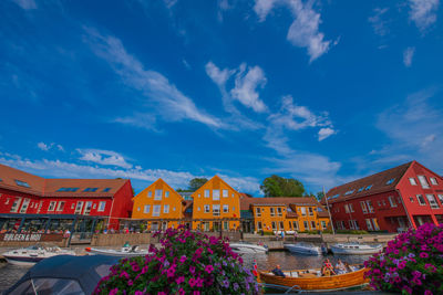 Low angle view of houses and buildings against blue sky