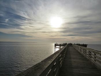 View of pier on sea during sunset