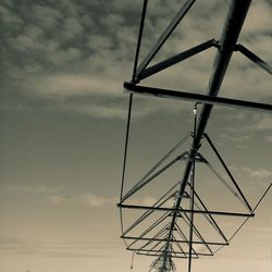 Low angle view of electricity pylon against sky