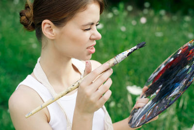 Side view of young woman looking at park