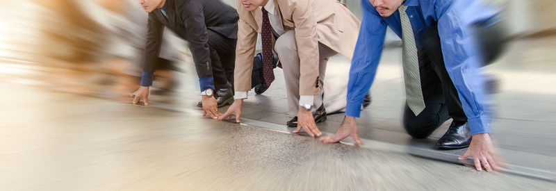 Business people in starting position on floor