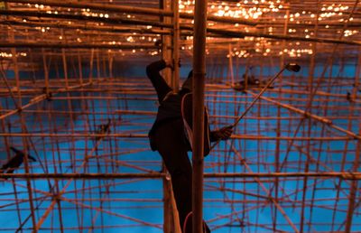 Directly below shot of man on scaffolding 