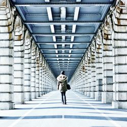 Full length of man walking on sidewalk