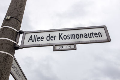 Low angle view of road sign against sky