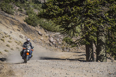 Man on touring motorbikes driving on gravel road in argentina