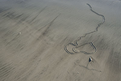 High angle view of heart shape on sand