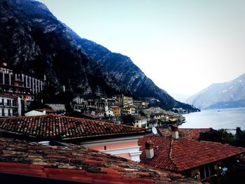 High angle view of houses and mountains against clear sky