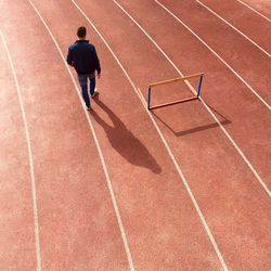 High angle view of man walking on running tracks