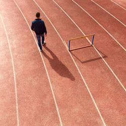 High angle view of man walking on running tracks