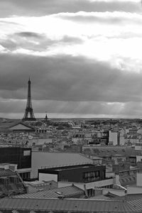 Buildings in city against cloudy sky