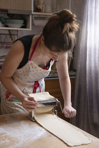 Side view of girl drawing on table