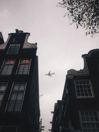 Low angle view of airplane flying against sky