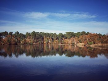 Scenic view of calm lake against cloudy sky