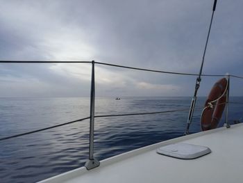 Boat sailing on sea against sky