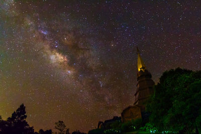 Low angle view of cross against sky at night