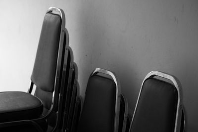 High angle view of empty chairs against wall