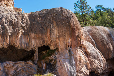 Low angle view of rock formation against sky