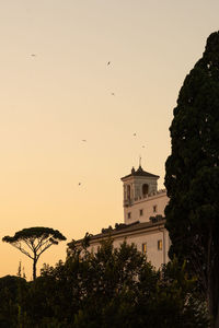 Low angle view of building and trees against sky