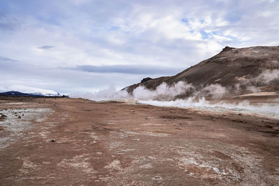 View of steam emitting from volcanic crater in geothermal area of hverir