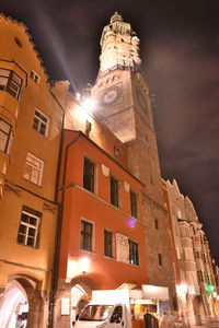 Low angle view of illuminated buildings against sky at night