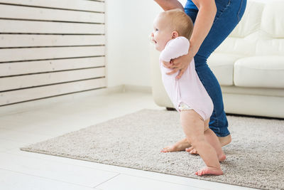 Mother playing with daughter at home