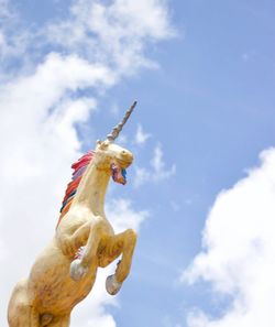 Low angle view of unicorn statue against sky