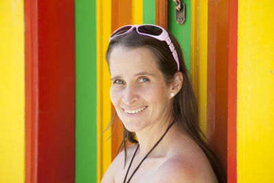 Young tourist woman next to one of the colorful doors of the guatape town in  antioquia in colombia