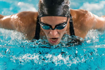 Portrait of young man swimming in pool