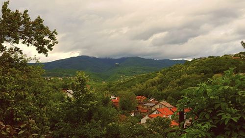 Scenic view of mountains against cloudy sky