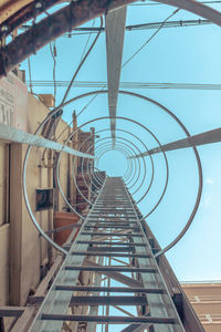 Low angle view of staircase in city against sky