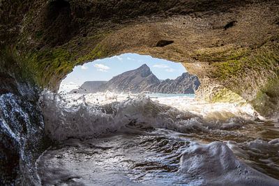 Scenic view of sea seen through rock formation