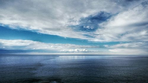 Scenic view of sea against cloudy sky