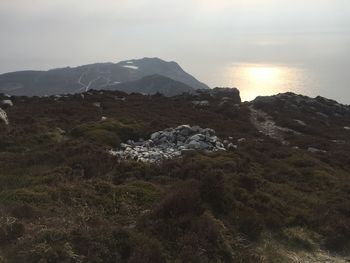 Scenic view of sea and mountains against sky