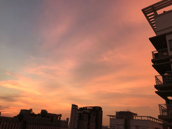 Low angle view of silhouette buildings against sky during sunset