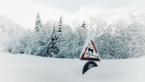 Scenic view of snow covered field against mountain