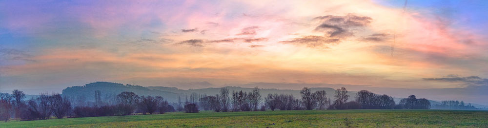 Scenic view of field against sky during sunset