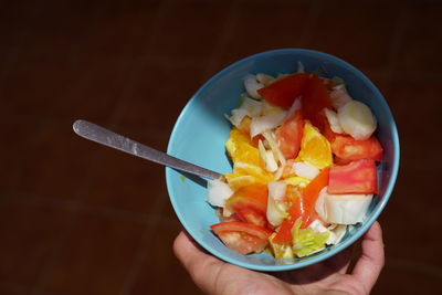 Close-up of person holding ice cream in bowl