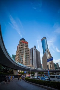 Low angle view of modern buildings against blue sky