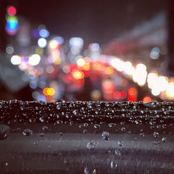 Defocused image of wet illuminated city at night