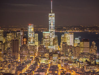 Aerial view of city lit up at night