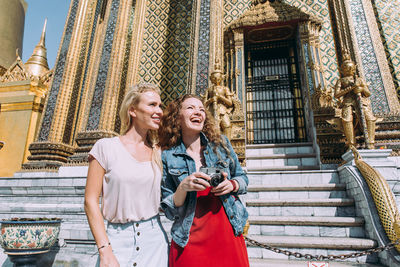 Happy women at temple in city