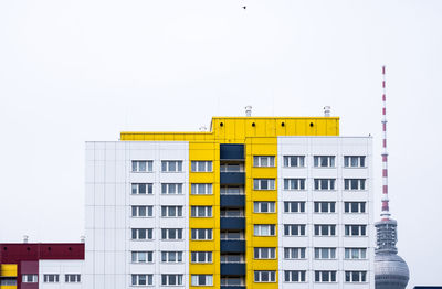 Low angle view of yellow building against clear sky