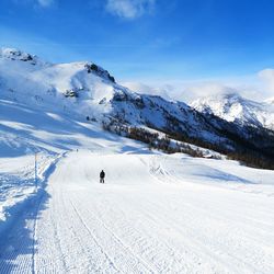 Scenic view of snow covered mountains against sky