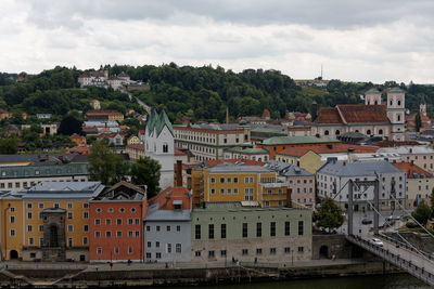 High angle view of buildings in town against sky