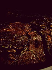 Illuminated cityscape against sky at night