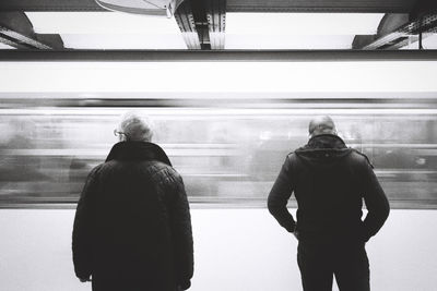 Rear view of man and woman sitting in bus