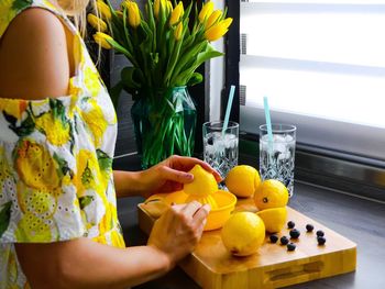 Woman squeezing lemons