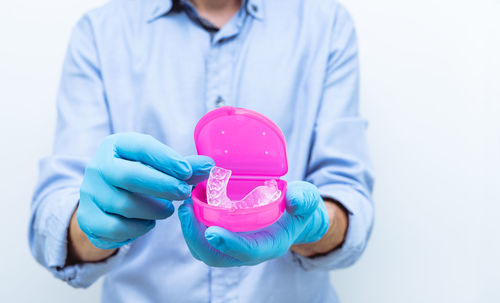 Midsection of man holding umbrella