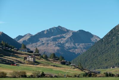 Scenic view of mountains against clear blue sky