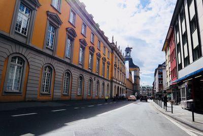 Street amidst buildings against sky in city